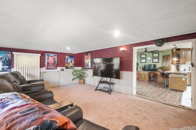 102 Southgate, Pleasanton, TX 78064 - carpeted living area with a ceiling fan and brick wall
