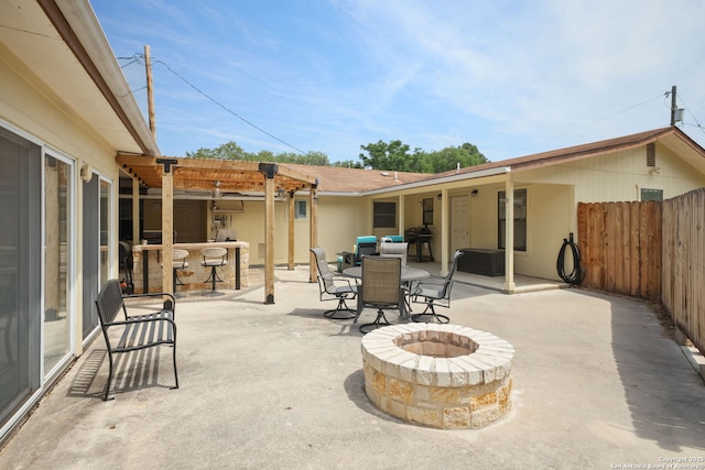 102 Southgate, Pleasanton, TX 78064 - view of patio / terrace featuring a fire pit, a pergola, and outdoor dining area