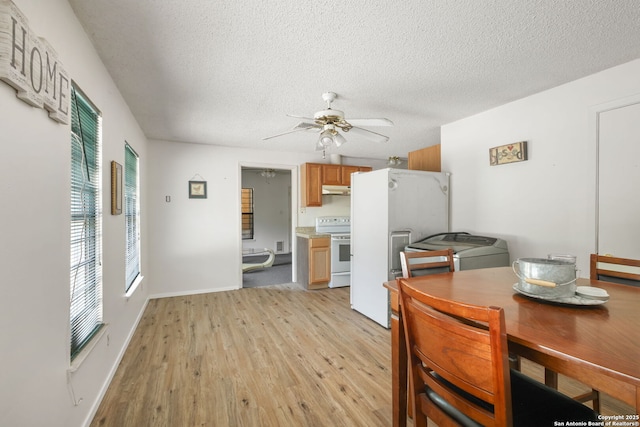 102 Southgate, Pleasanton, TX 78064 - dining area with light wood-style floors, a textured ceiling, ceiling fan, and baseboards