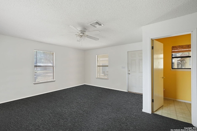 102 Southgate, Pleasanton, TX 78064 - carpeted spare room featuring ceiling fan, plenty of natural light, a textured ceiling, and baseboards