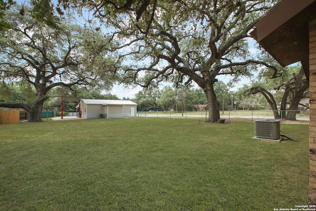 102 Southgate, Pleasanton, TX 78064 - view of yard with cooling unit, an outbuilding, and a garage