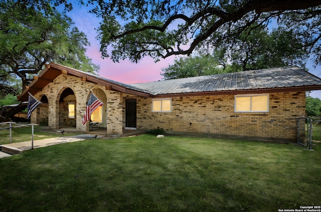 102 Southgate, Pleasanton, TX 78064 - ranch-style home with brick siding, a patio area, and metal roof