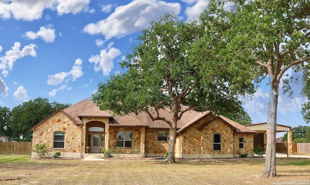156 Vintage Rnch, La Vernia, TX 78121 - view of front of property with stone siding and roof with shingles