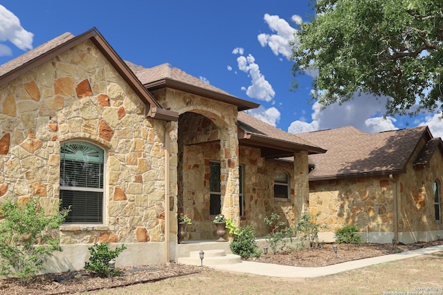 156 Vintage Rnch, La Vernia, TX 78121 - property entrance featuring stone siding and roof with shingles