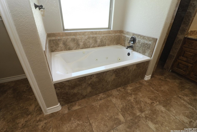 156 Vintage Rnch, La Vernia, TX 78121 - bathroom with a whirlpool tub and a textured wall
