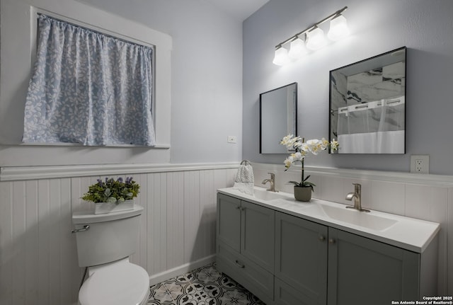 721 W Kings Hwy, San Antonio, TX 78212 - full bath with wainscoting, double vanity, toilet, a shower, and tile patterned flooring