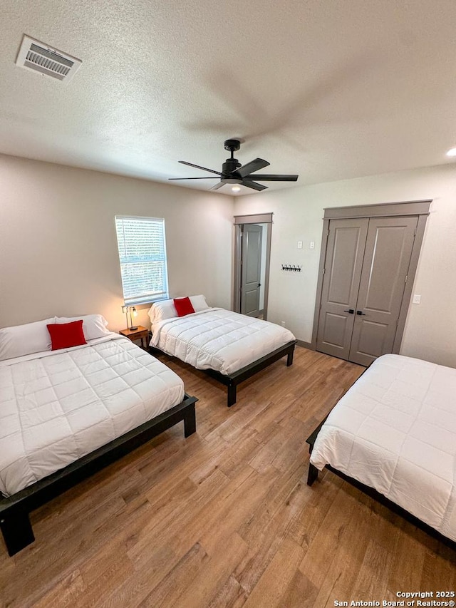 34 Lazy Day, Concan, TX 78838 - bedroom featuring wood finished floors, ceiling fan, and a closet