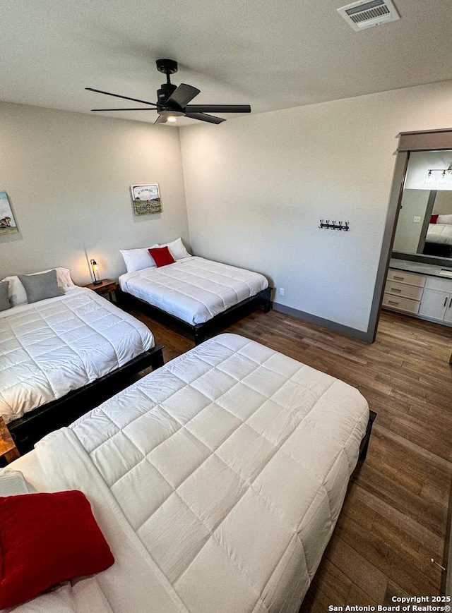 34 Lazy Day, Concan, TX 78838 - bedroom with wood finished floors, baseboards, and ceiling fan