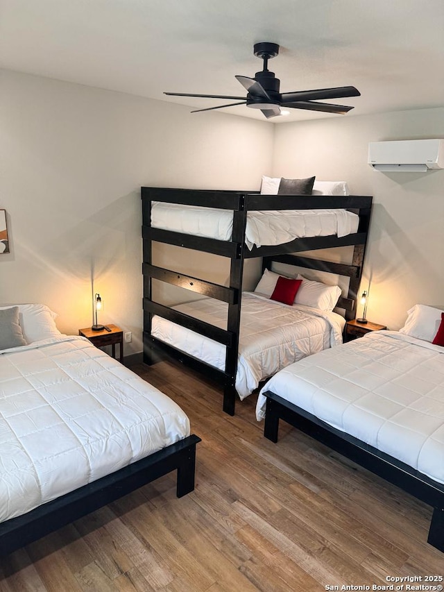 34 Lazy Day, Concan, TX 78838 - bedroom with wood finished floors, ceiling fan, and an AC wall unit