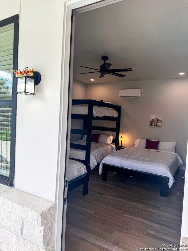 34 Lazy Day, Concan, TX 78838 - bedroom with a wall mounted AC, wood finished floors, and recessed lighting