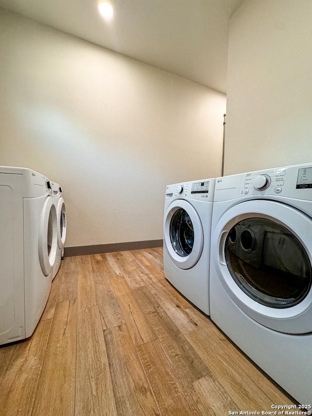 34 Lazy Day, Concan, TX 78838 - laundry room featuring independent washer and dryer, light wood-style floors, and baseboards