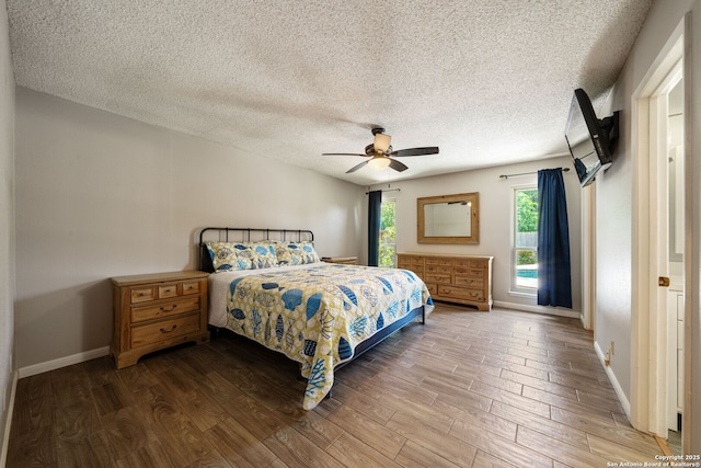 2102 Oak Wild St, San Antonio, TX 78232 - bedroom featuring wood finished floors, baseboards, a textured ceiling, and ceiling fan