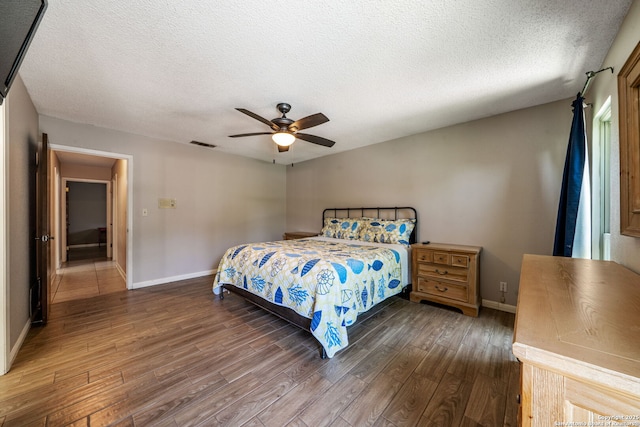 2102 Oak Wild St, San Antonio, TX 78232 - bedroom featuring wood finished floors, baseboards, a textured ceiling, and ceiling fan
