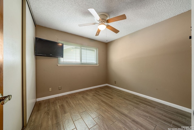 2102 Oak Wild St, San Antonio, TX 78232 - empty room featuring wood finished floors, ceiling fan, a textured ceiling, and baseboards