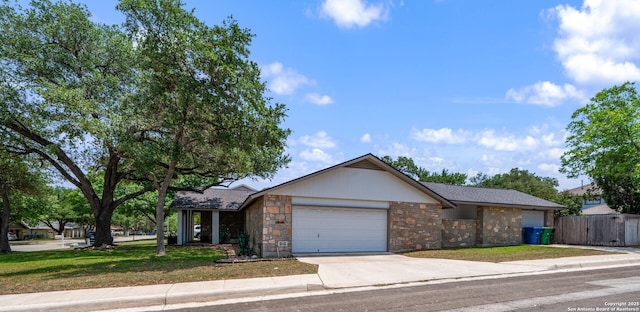 2102 Oak Wild St, San Antonio, TX 78232 - view of front facade with stone siding, driveway, and an attached garage