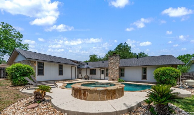 2102 Oak Wild St, San Antonio, TX 78232 - rear view of property with a patio area, a chimney, a shingled roof, and a pool with connected hot tub