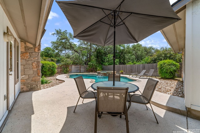 2102 Oak Wild St, San Antonio, TX 78232 - fenced backyard with a patio area, outdoor dining area, and a pool with connected hot tub
