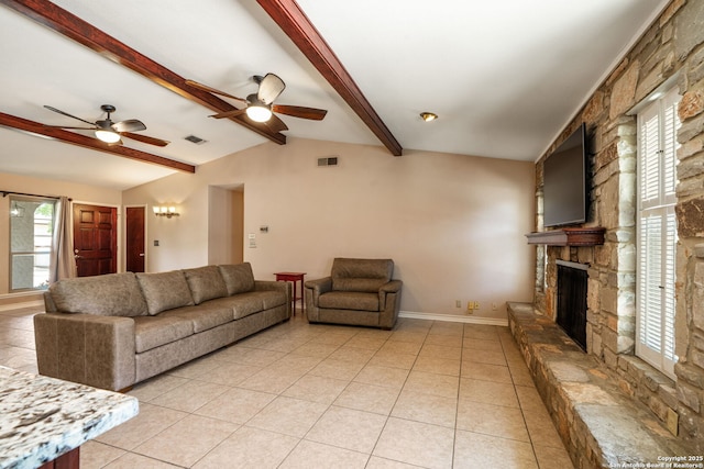2102 Oak Wild St, San Antonio, TX 78232 - living room featuring a stone fireplace, a ceiling fan, light tile patterned flooring, and baseboards
