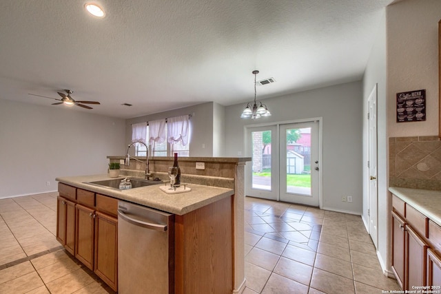 112 Springtree Bnd, Cibolo, TX 78108 - kitchen featuring a sink, dishwasher, light tile patterned floors, brown cabinets, and hanging light fixtures