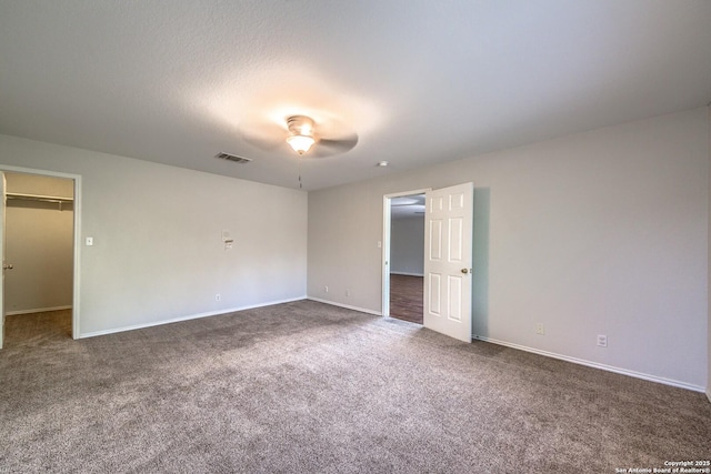 112 Springtree Bnd, Cibolo, TX 78108 - unfurnished bedroom featuring carpet floors, a spacious closet, baseboards, and ceiling fan