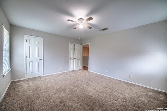 112 Springtree Bnd, Cibolo, TX 78108 - unfurnished bedroom featuring carpet floors, baseboards, multiple closets, and a ceiling fan