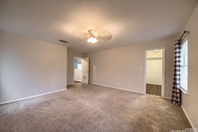 112 Springtree Bnd, Cibolo, TX 78108 - empty room featuring a ceiling fan, carpet floors, baseboards, and a textured ceiling