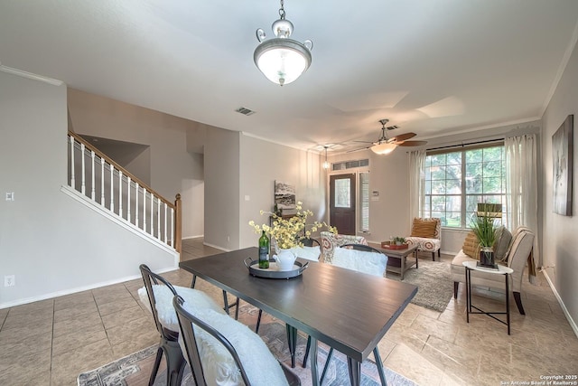 112 Springtree Bnd, Cibolo, TX 78108 - dining area featuring stairway, baseboards, ceiling fan, ornamental molding, and light stone finish floors