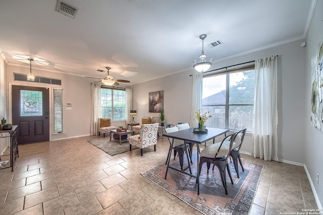 112 Springtree Bnd, Cibolo, TX 78108 - dining area featuring baseboards, crown molding, stone tile flooring, and ceiling fan