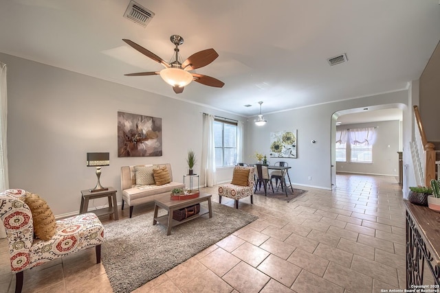 112 Springtree Bnd, Cibolo, TX 78108 - living area featuring arched walkways, a ceiling fan, light tile patterned floors, and baseboards