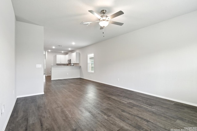 7150 Pisces, Converse, TX 78109 - unfurnished living room with dark wood-style flooring, ceiling fan, baseboards, and recessed lighting