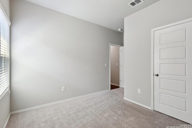7150 Pisces, Converse, TX 78109 - unfurnished bedroom with multiple windows, carpet flooring, and baseboards