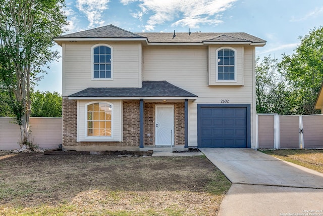 2602 Leslie Nicole, San Antonio, TX 78237 - traditional home with an attached garage, concrete driveway, roof with shingles, and brick siding