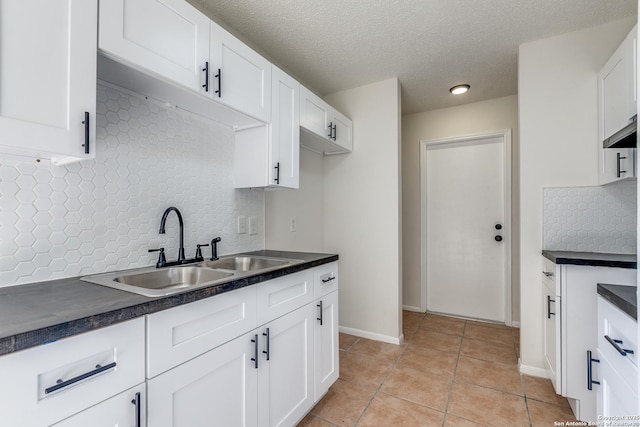 2602 Leslie Nicole, San Antonio, TX 78237 - kitchen featuring a sink, dark countertops, decorative backsplash, and a textured ceiling