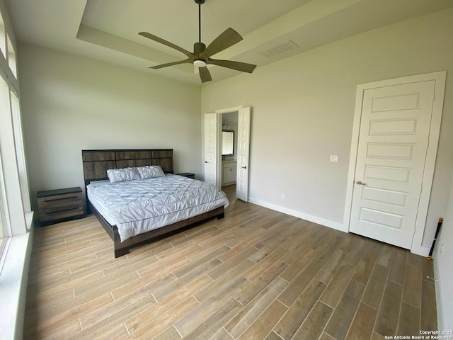1185 Abelia, New Braunfels, TX 78132 - bedroom featuring wood finished floors, baseboards, ceiling fan, and ensuite bathroom