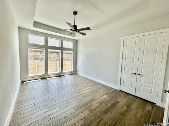 1185 Abelia, New Braunfels, TX 78132 - unfurnished room featuring ceiling fan, dark wood-style floors, a raised ceiling, and baseboards
