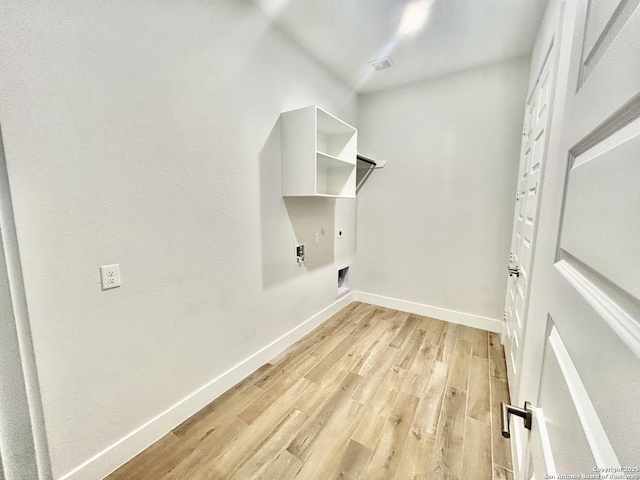 1185 Abelia, New Braunfels, TX 78132 - laundry room featuring electric dryer hookup, light wood-type flooring, and baseboards