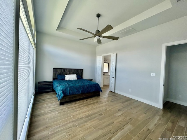 1185 Abelia, New Braunfels, TX 78132 - bedroom with light wood-style flooring, baseboards, connected bathroom, and ceiling fan