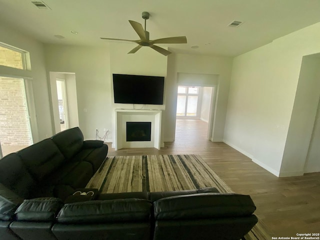 1185 Abelia, New Braunfels, TX 78132 - living room featuring wood finished floors, a fireplace, ceiling fan, and baseboards