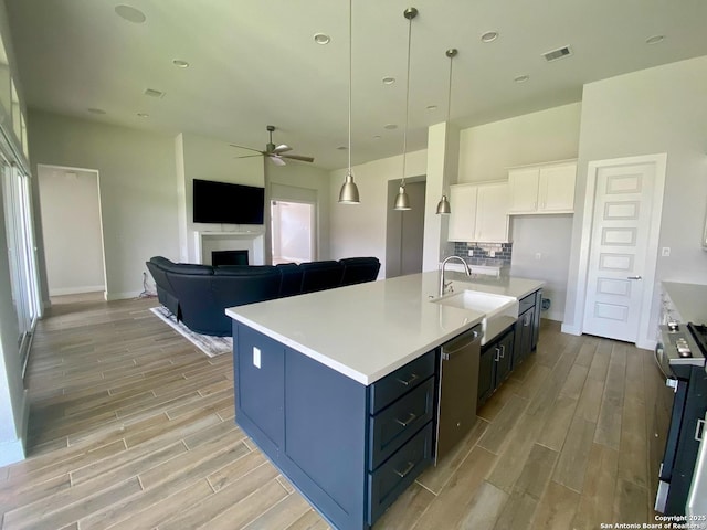 1185 Abelia, New Braunfels, TX 78132 - kitchen with a sink, light wood-style floors, ceiling fan, white cabinets, and recessed lighting