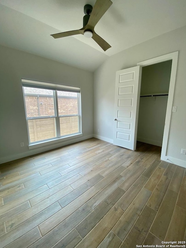 1185 Abelia, New Braunfels, TX 78132 - unfurnished bedroom with wood finished floors, a closet, baseboards, and a ceiling fan