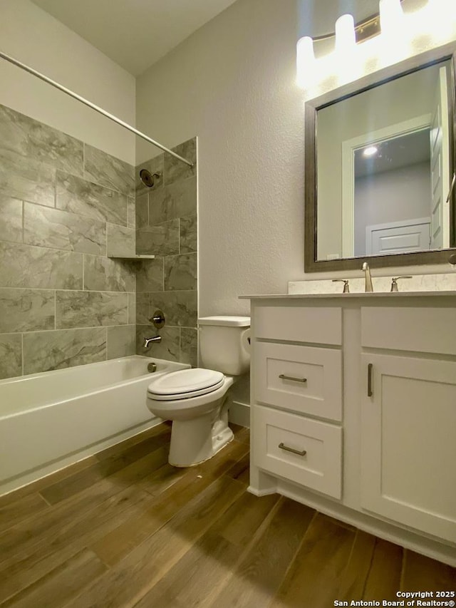 1185 Abelia, New Braunfels, TX 78132 - bathroom featuring wood finished floors, toilet, tub / shower combination, vanity, and a textured wall