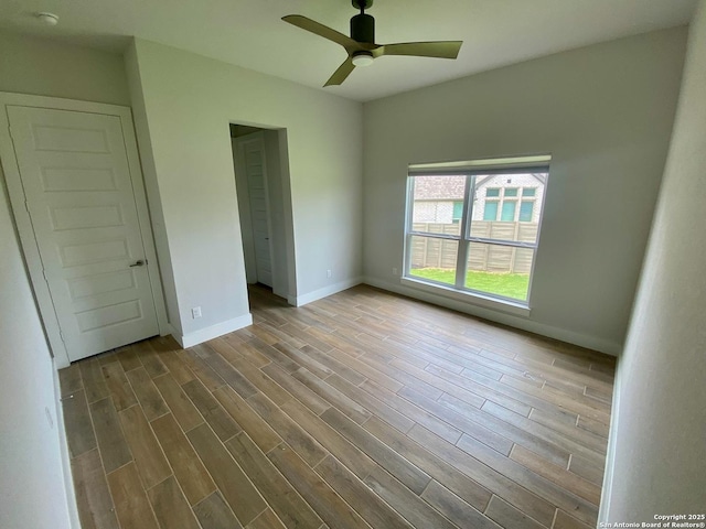1185 Abelia, New Braunfels, TX 78132 - unfurnished bedroom featuring baseboards, wood finished floors, and a ceiling fan