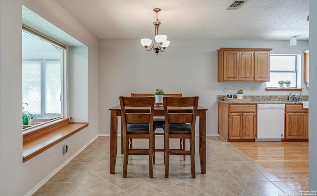 3828 Hunters Gln, Schertz, TX 78108 - dining room featuring a chandelier, a textured ceiling, and light tile patterned floors