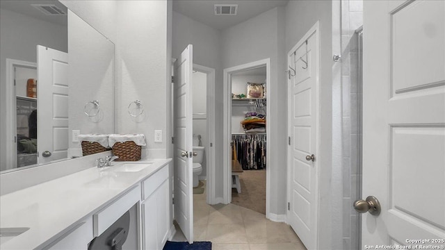 229 Colebrook Way, Cibolo, TX 78108 - bathroom featuring double vanity, tile patterned flooring, toilet, a spacious closet, and a shower