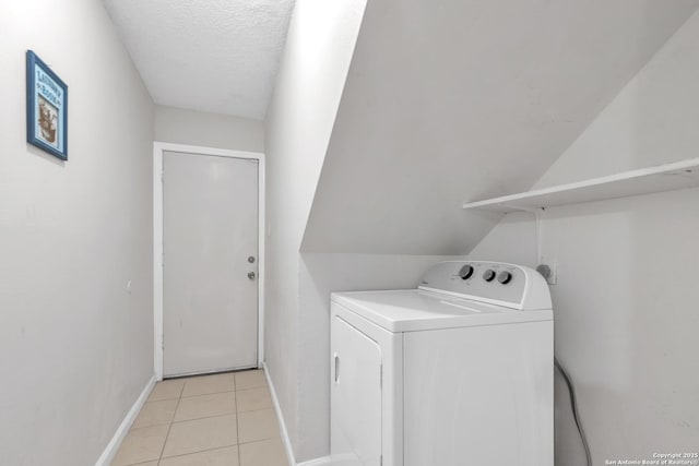 10222 Canton Fld, San Antonio, TX 78245 - laundry area with washer / dryer, light tile patterned floors, baseboards, and a textured ceiling