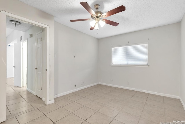 10222 Canton Fld, San Antonio, TX 78245 - spare room with a ceiling fan, a textured ceiling, light tile patterned floors, and baseboards