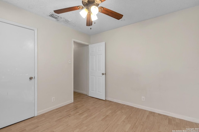 10222 Canton Fld, San Antonio, TX 78245 - unfurnished bedroom with light wood-type flooring, baseboards, a textured ceiling, and a ceiling fan
