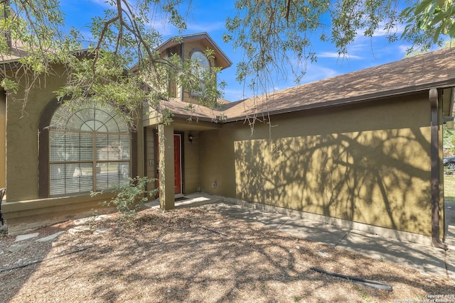 10222 Canton Fld, San Antonio, TX 78245 - property entrance with stucco siding and a shingled roof