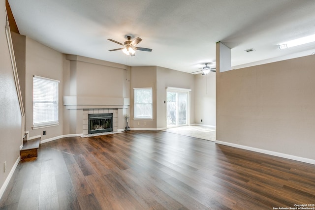 9331 Autumn Sunrise, San Antonio, TX 78254 - unfurnished living room featuring a ceiling fan, plenty of natural light, wood finished floors, and a fireplace