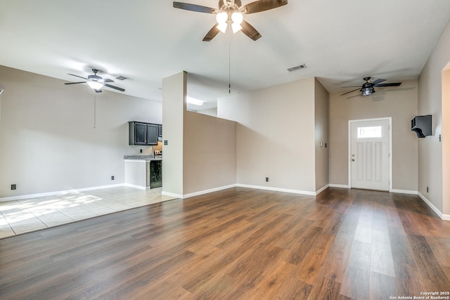 9331 Autumn Sunrise, San Antonio, TX 78254 - unfurnished living room featuring ceiling fan, baseboards, wood finished floors, and vaulted ceiling